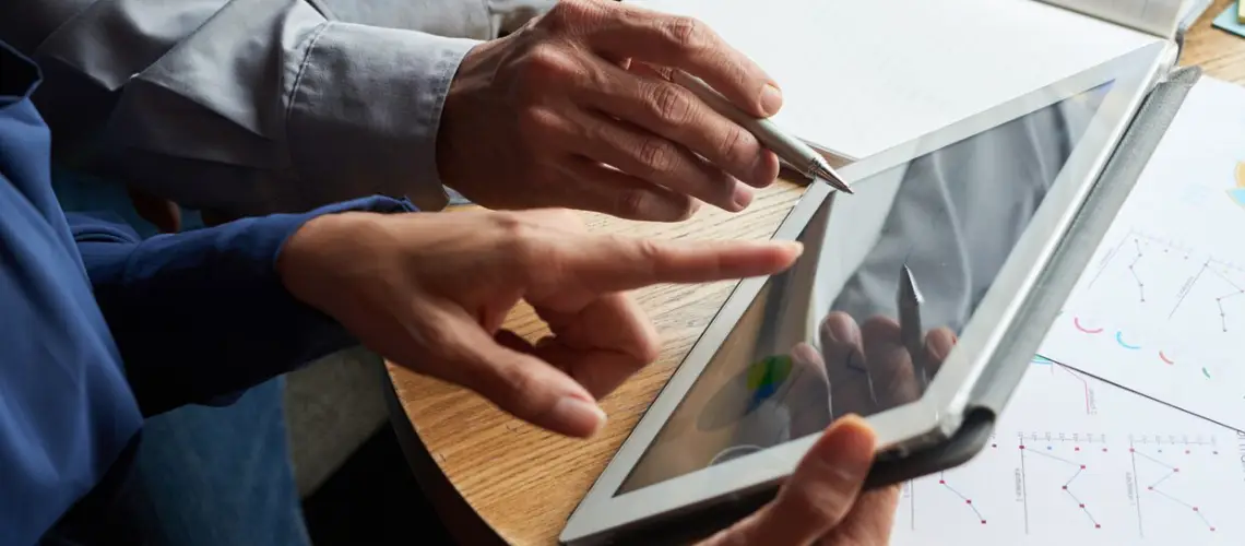 Valuer using digital valuation tools on a tablet for property assessment